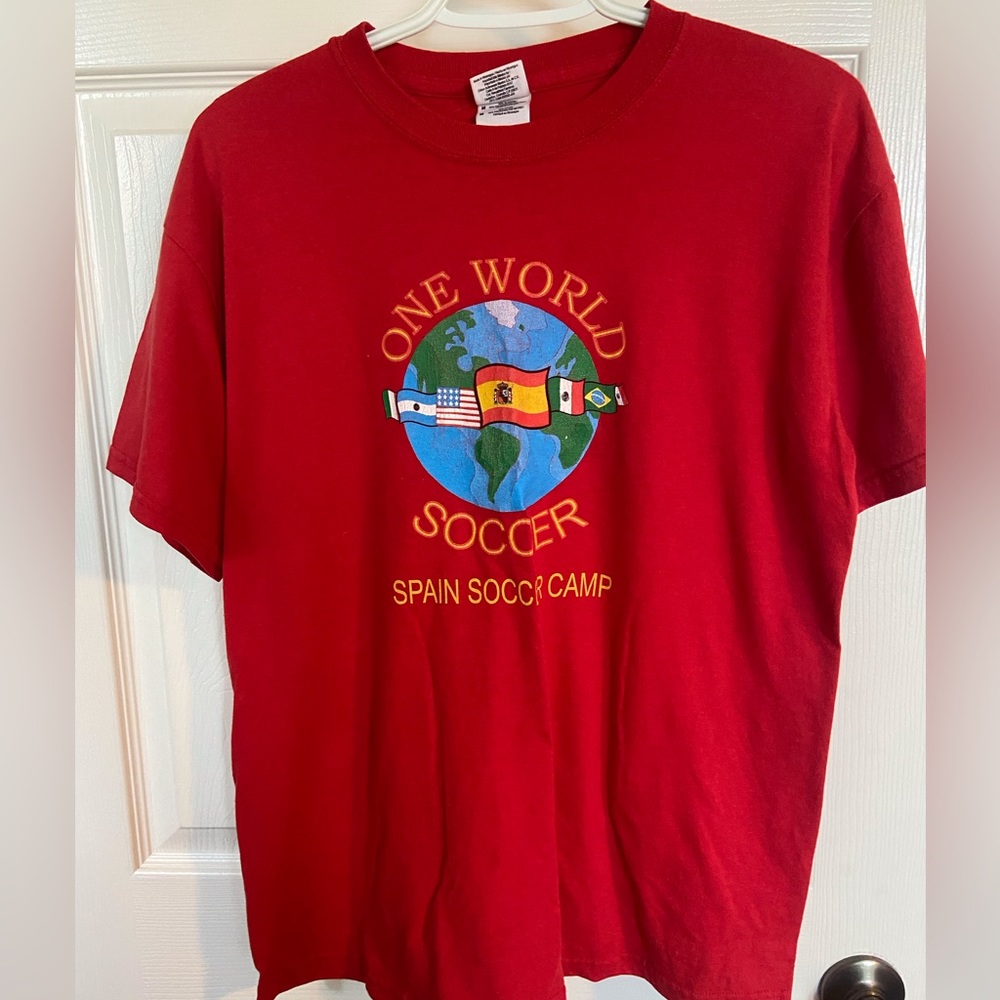 One World Soccer camp tee, size medium